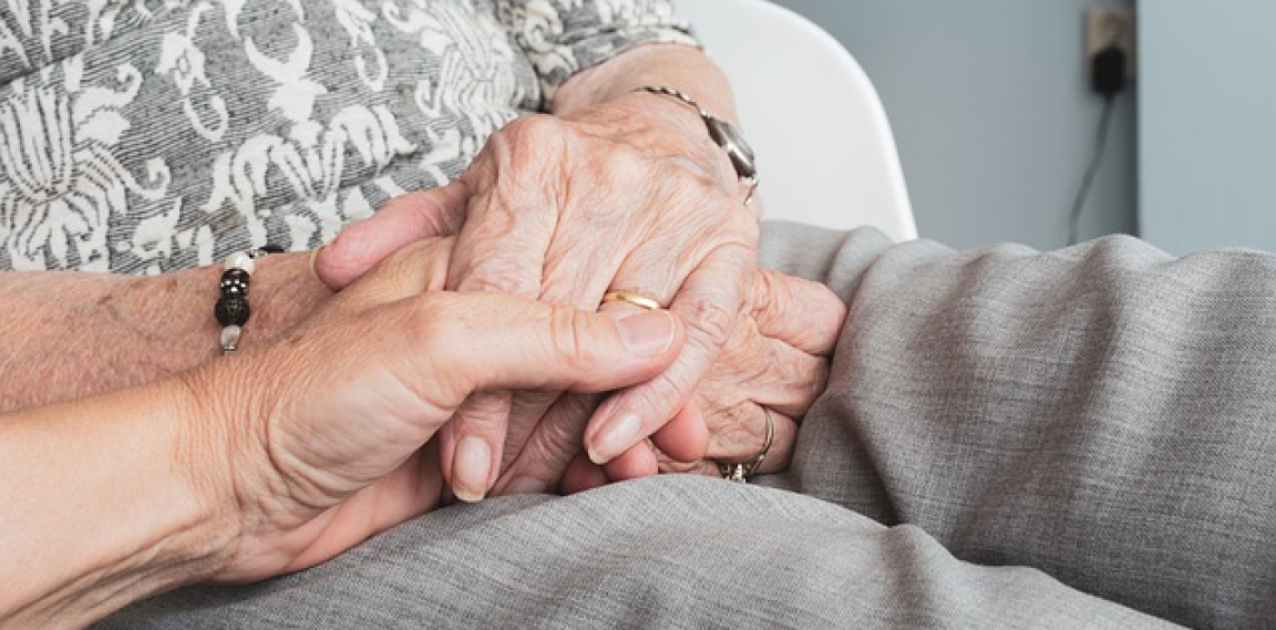 An old couple holding hands