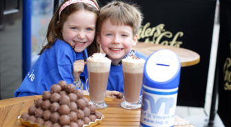 Kids smiling with svp donation box