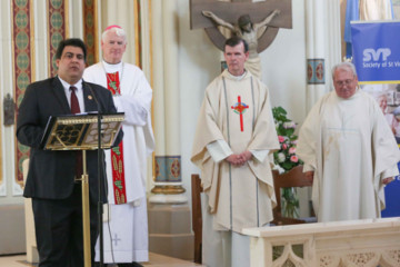 Man standing with priests