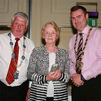 The Lord Mayor and Deputy Lord Mayor of Armagh City and District present Anne McArdle with the Volunteer of the Year.