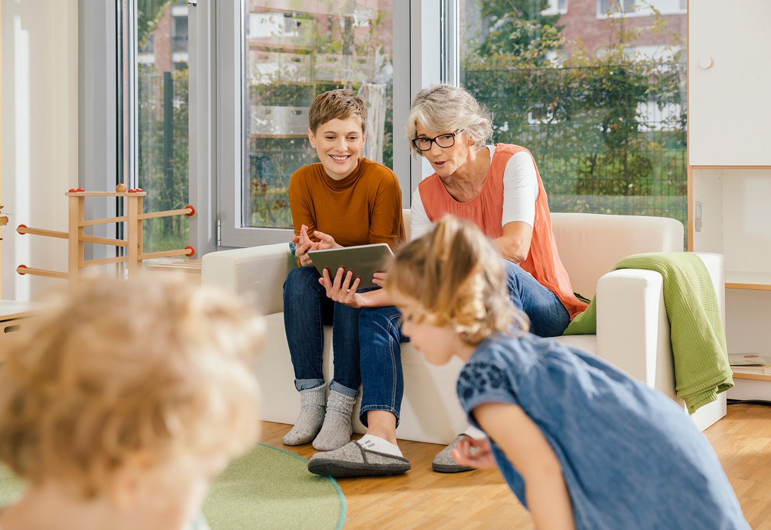 Two teachers looking at kids play